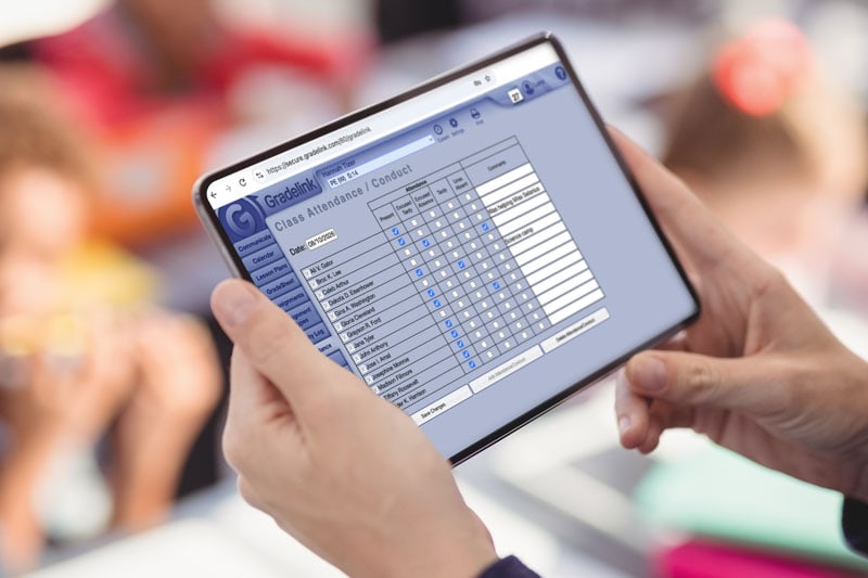 Teacher Taking Attendance on a Tablet